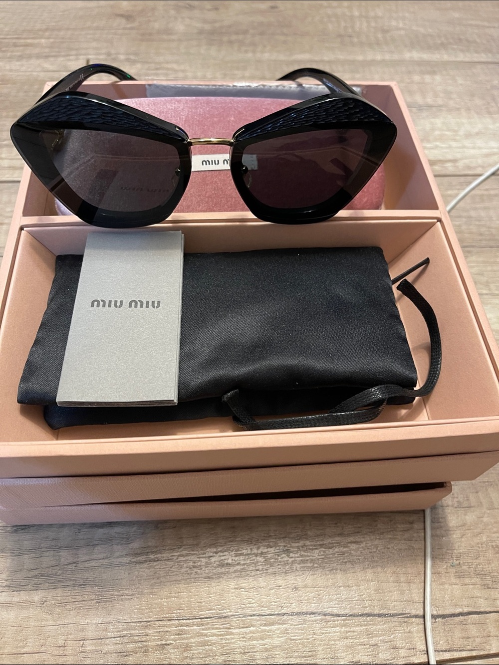 Miu Miu
Miu Miu Black / Grey SMU 01X Charms Aviator Sunglasses